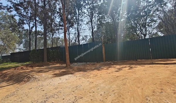 Perimeter fencing securing the lush green construction site of Godrej Bannerghatta