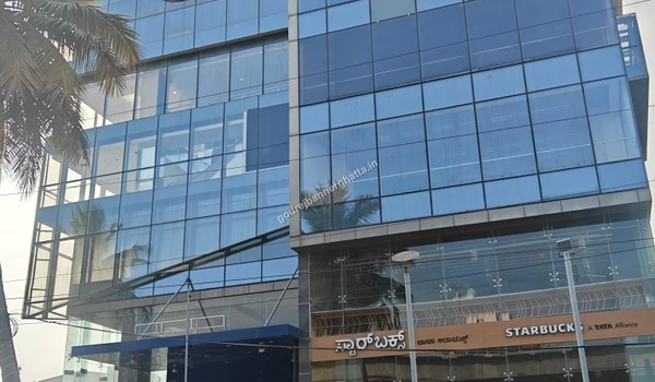 Modern commercial building housing a Starbucks coffee shop near the site
